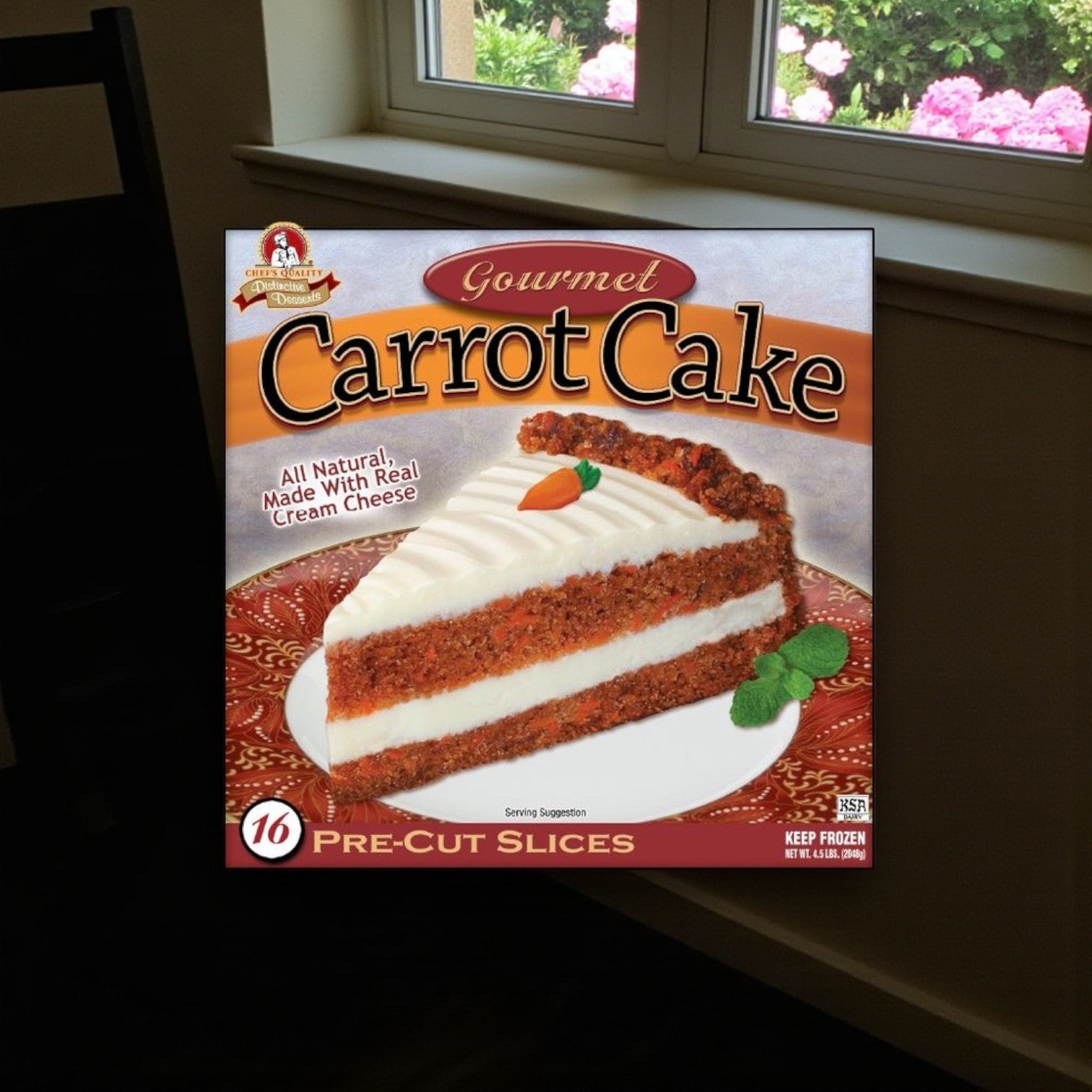 Easy Lunches Frozen Chef’s Quality Carrot Cake with Cream Cheese Icing comes in a 4 lb box with 16 pre-cut slices, shown on the packaging topped with real cream cheese icing—a delicious frozen dessert for any occasion.