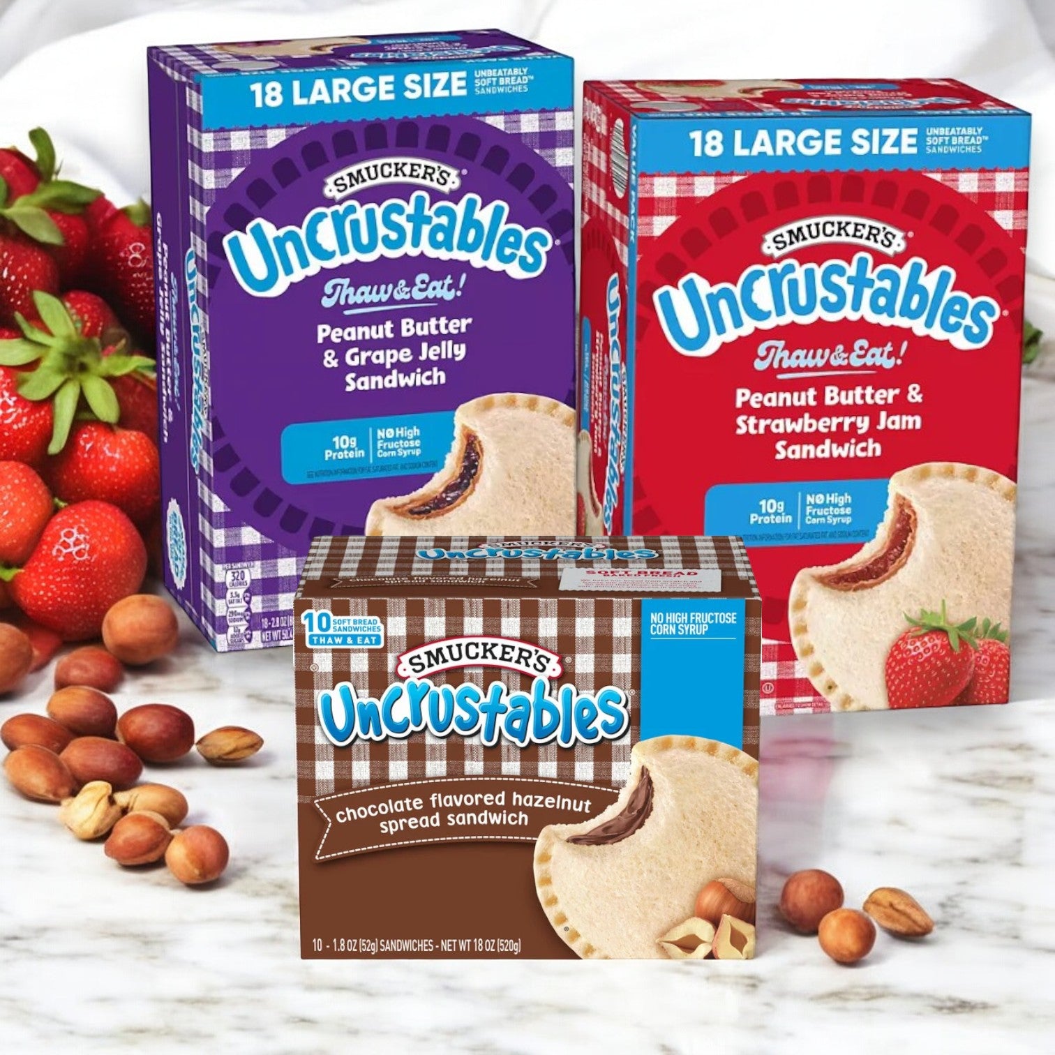 A bundle of Uncrustable Smuckers' Uncrustables, featuring 46 total sandwiches including 18 Peanut Butter & Grape Jelly, 18 Peanut Butter & Strawberry Jam, and 10 Chocolate Flavored Hazelnut Spread, is displayed—perfect for quick school lunches.