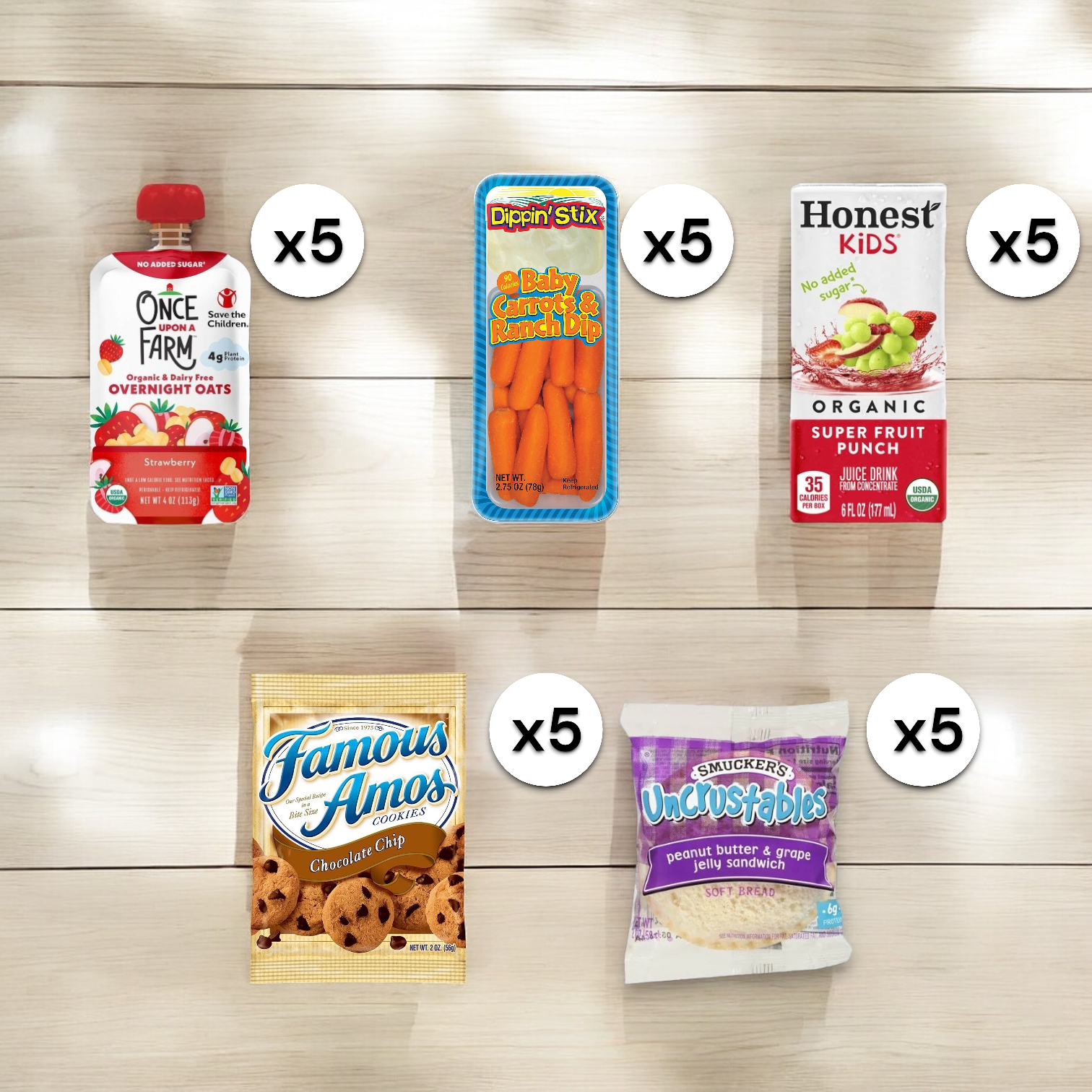 A selection of snacks including five Once Upon A Farm Strawberry pouches, five Dippin' Stix Baby Carrots & Ranch Dip packs, five Honest Kids Fruit Punch Juice Boxes, five Famous Amos Cookie Bags, and one Grape Uncrustables Lunch Pack.